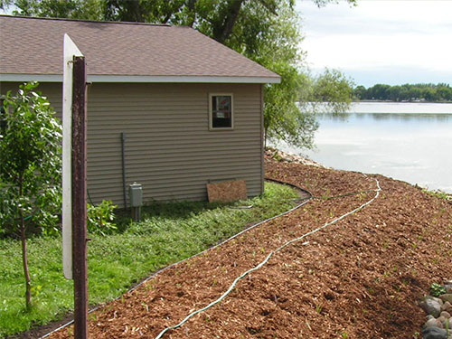 Mulch and rock placed around shoreline for erosion control purposes
